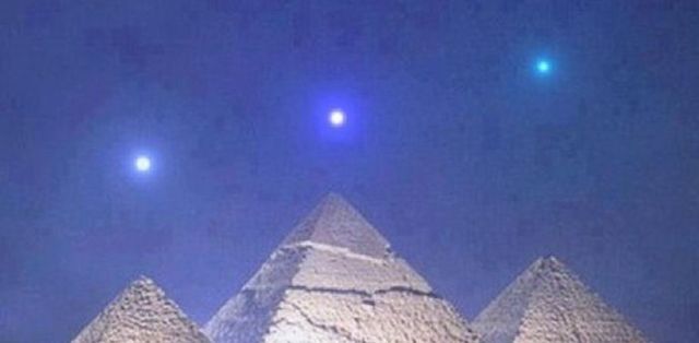 the 3 pyramids of Giza with 3 stars perfectly aligned over them. 