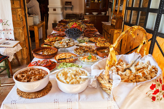 overfilled table with tasty food