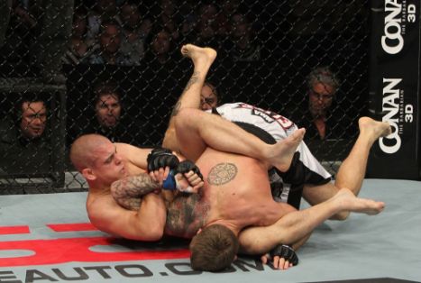 two mma fighters wrestling in the ring