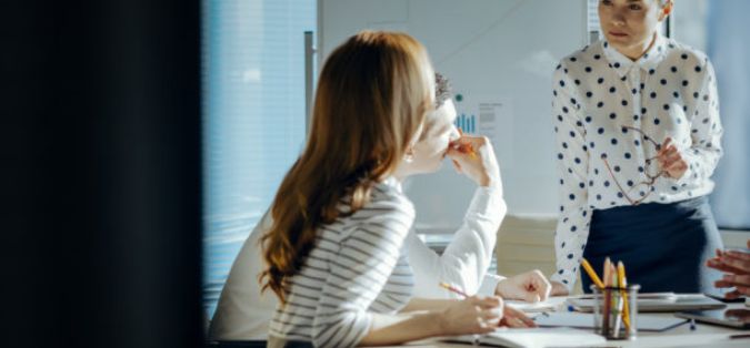 woman listen intently to another woman in an office environment